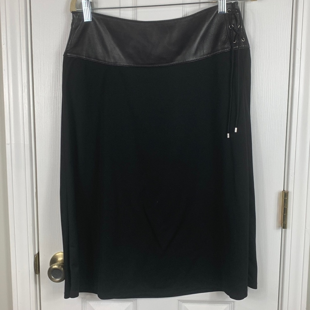 Michael Kors black skirt size 8. Top is 100% leather tie on the side. Rest poly.